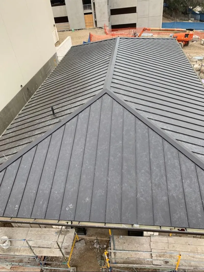 Commercial metal roof construction with crane equipment in Cullowhee